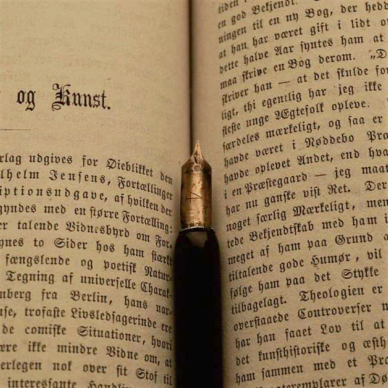 A pen lying in an old book.